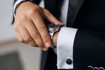 Man is looking at the watch on his wrist, closeup, without face